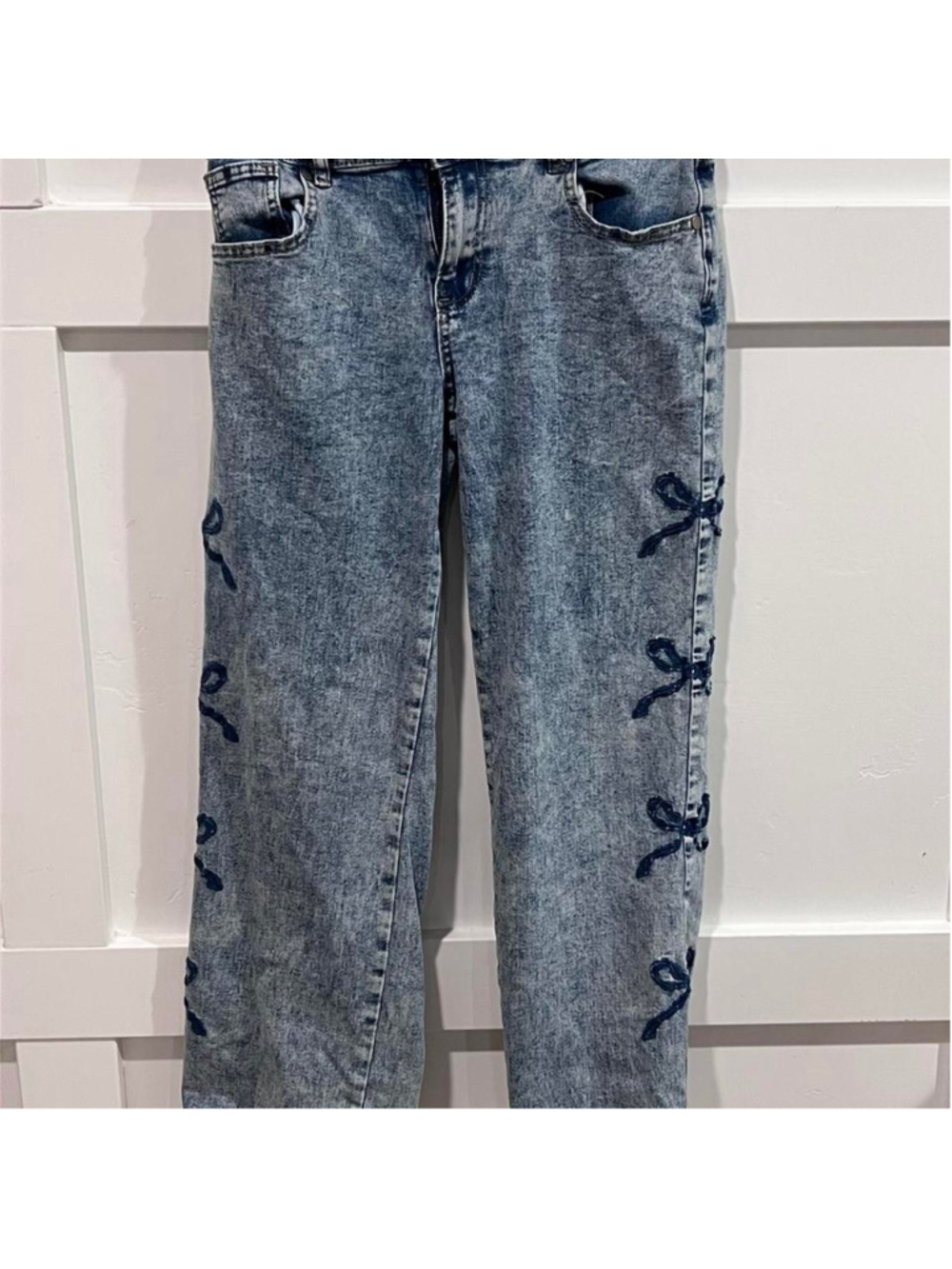 Your Cute Jeans blue denim jeans with dark blue bow embroidery along the outer s